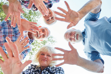 Waving hands of seniors in summer