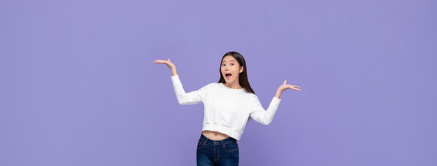Excited Asian woman doing presenting gesture with both hands open