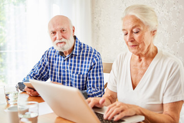 Senior couple using e-learning on laptop