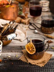 homemade mulled red wine with cinnamon, anise, cardamon and orange in glass jars