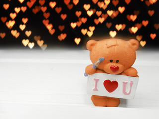 valentine's day composition of teddy bear and hearts