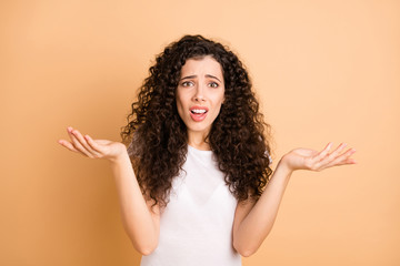 What's wrong. Photo of pretty lady raising hands air not believe eyes unfair situation wear white...