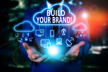 Writing note showing Build Your Brand. Business concept for creates or improves customers knowledge...