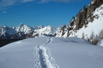 Fototapeta na wymiar Winter mountains. Track in the snow.