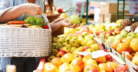 Young woman shopping healthy food on the market