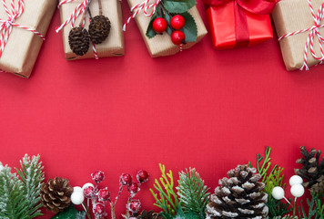 Christmas red background with surprise gift boxes and copy space. Winter holidays with presents, top view, flat lay.