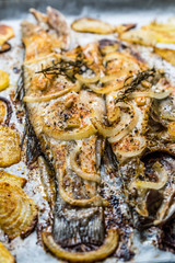 Fillet of Sea Bass Grilled with Potatoes and Onions in Baking Tray with Oven.