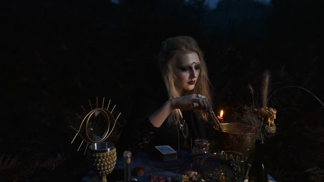 Halloween Image. Young Witch Prepares Magic Drink In Bowls.