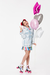 Image of joyful young woman gesturing peace sign and holding balloons