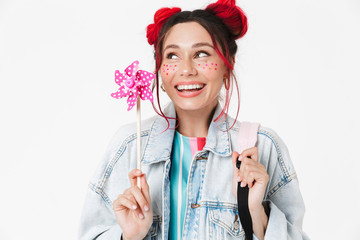 Image of smiling woman holding flower wind spinner and looking aside