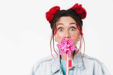 Image of cute woman s holding flower wind spinner and looking at camera