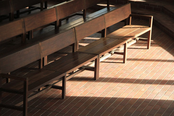 Obraz na płótnie Canvas Sunlight projected on the church's benches.