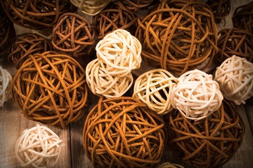 Background with decorative rattan balls on a wooden surface