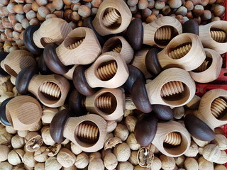 Wooden device for cracking the shells of daisies on a pile of walnuts. Riga. Latvia. February 2019