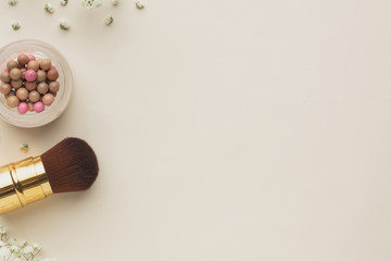 Makeup brush and blush on table copy-space