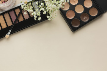 Makeup palettes on table with brush