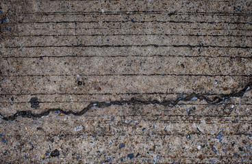 Photo of the cracked surface of a concrete floor