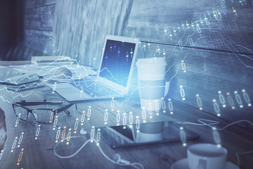 Stock market graph on background with desk and personal computer. Multi exposure. Concept of financial analysis.