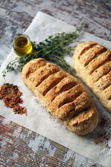 Fresh homemade italian bread with herbs and spices. Selective focus. Macro.