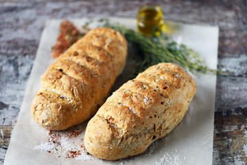 Fresh homemade italian bread with herbs and spices. Selective focus. Macro.
