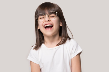 Overjoyed little girl wear glasses laugh feeling happy