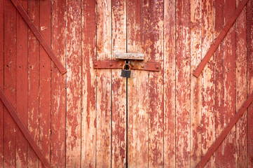 Vintage wood background. Grunge wooden weathered oak or pine textured planks. Aged brown or red color. An old worn barn or antique wooden fence with chipped red paint