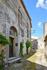 Fototapeta na wymiar Province of Salerno, Italy, 05/27/2017. A narrow street among the old houses of a mountain village.