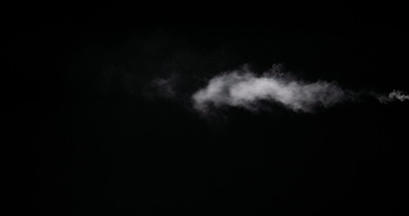 Real white smoke isolated on black background with visible droplets