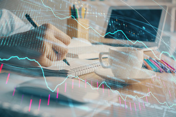 Financial chart drawn over hands taking notes background. Concept of research. Double exposure