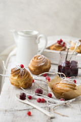 Decorating homemade dessert with sugar powder and dried berries. Cruffin dessert.
