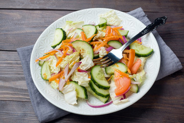 Vegetarian salad of raw fresh vegetables in a plate. Concept healthy eating Copy space