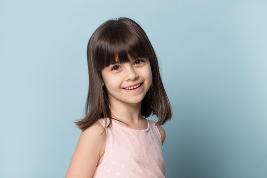 Close up of smiling little girl posing in studio