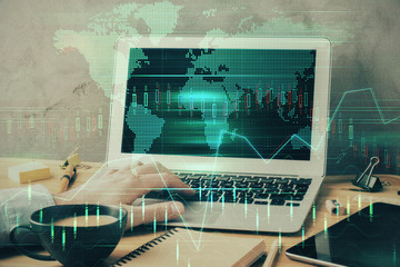 Forex graph with businessman working on laptop on background. Concept of hardworking. Multi exposure.