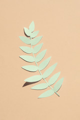 Isolated blue artificial leaf on pink background