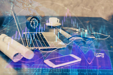 Financial market graph hologram and personal computer on background. Double exposure. Concept of forex.