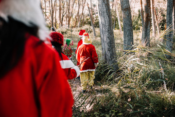 Group of people disguised to christmas on the forest