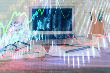 Financial market graph hologram and personal computer on background. Multi exposure. Concept of forex.