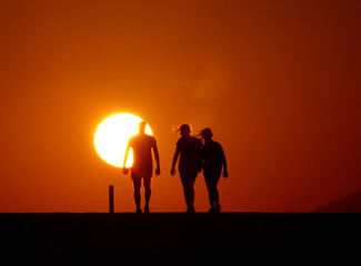 silhouette of man and woman at sunset