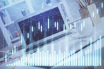 Double exposure of chart and financial info and work space with computer background. Concept of...