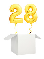 Golden number twenty eight inflatable balloon with golden ribbon flying out of blank white box isolated on white background