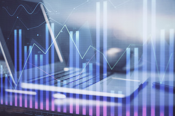 Forex market chart hologram and personal computer background. Double exposure. Concept of investment.