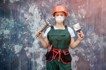 Woman in helmet and mask holding spatula and hammer on abstract background