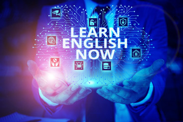 Word writing text Learn English Now. Business photo showcasing gain or acquire knowledge and skill of english language Male human wear formal work suit presenting presentation using smart device