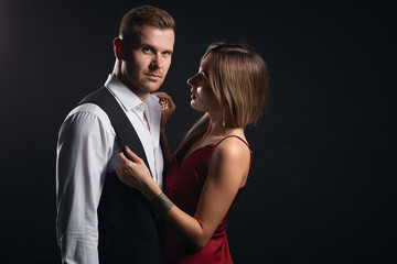 Portrait of young handsome man with beautiful awesome young woman standing over black background studio shot.copy space. family . love, relationshop, passion