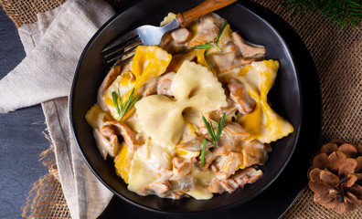 Colorful farfalle pasta with chanterelles and cream sauce.