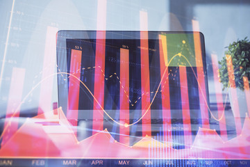 Forex Chart hologram on table with computer background. Double exposure. Concept of financial markets.