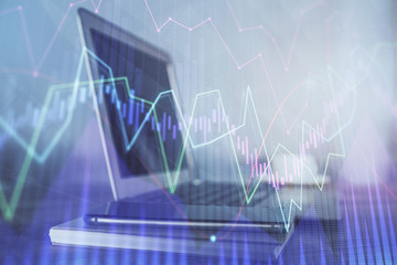 Stock market graph and table with computer background. Double exposure. Concept of financial analysis.