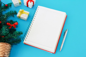notebook for notes and a green Christmas tree with New Year's decor