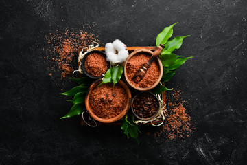 Sea salt with coffee beans. On a black stone background. Spa treatments. Top view. Free copy space.
