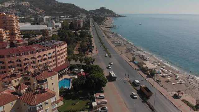 Panoramic aerial view of urban landscape, coastline and beaches from Mahmutlar to Kargicak on the Turkish Mediterranean Coast. Tourists and locals enjoy vacations. The D400 runs alongside the beaches